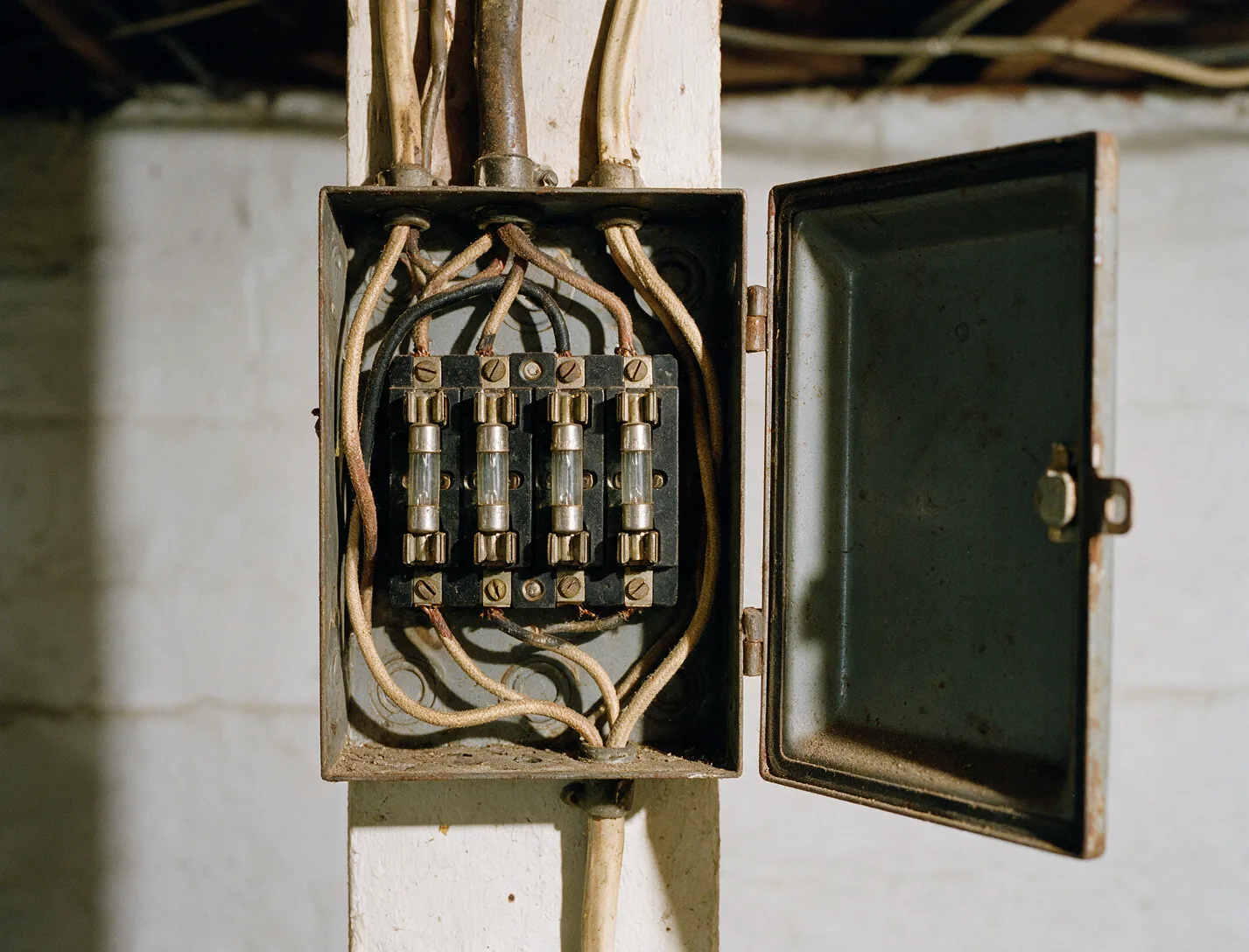 An old fuse box in a basement